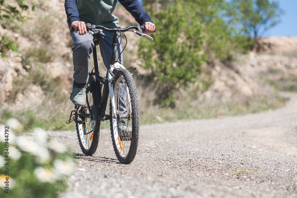 Unrecognizable person on a bike riding down a way. Outdoor activities Unrecognizable person on a bike riding down a way. Outdoor activities