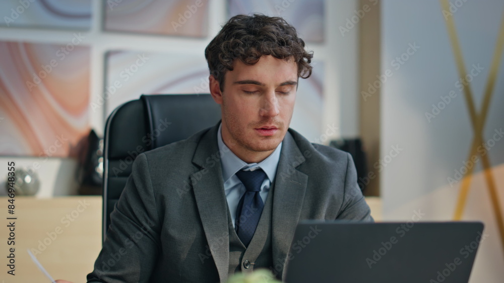 Thoughtful leader looking papers check project information at cabinet closeup Thoughtful leader looking papers check project information at cabinet closeup