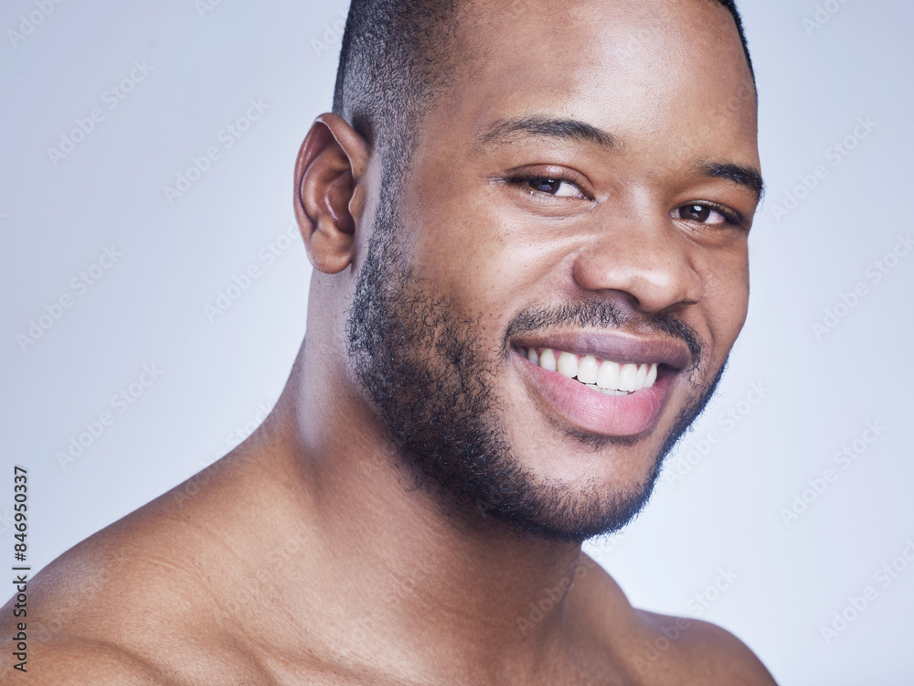Obraz premium Black man, happy and skincare in studio portrait, facial treatment and cosmetics on blue background. Male person, healthy and pamper for dermatology, grooming and confident for smooth or clean skin
