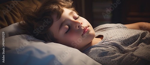 Little boy peacefully snores in his sleep, tucked in bed with a soft pillow under his head. with copy space image. Place for adding text or design