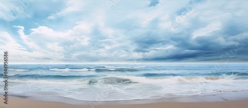 Dark clouds gather over the turbulent ocean with crashing waves on the sandy beach. with copy space image. Place for adding text or design