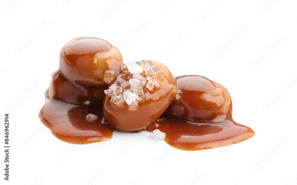 Yummy candies with caramel sauce and sea salt isolated on white Yummy candies with caramel sauce and sea salt isolated on white