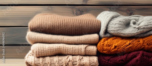 Stack of cozy sweaters on a...