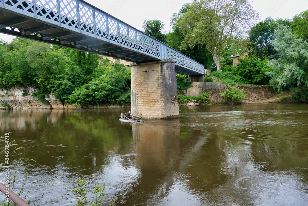 Large tree trunks swept down the Vezere River following heavy rains and flooding. Finally coming to rest against the stone supports of the iron bridge across the Vezere river in St Leon sur Vezere in Large tree trunks swept down the Vezere River following heavy rains and flooding. Finally coming to rest against the stone supports of the iron bridge across the Vezere river in St Leon sur Vezere in