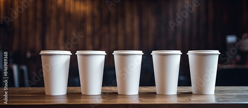 Four white disposable cups ...