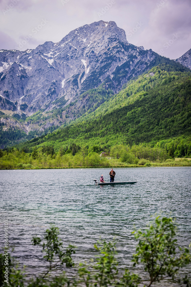 A beautiful view on the Ehrwalder Almsee and the Zugspitze on a sunny summer day in Austria, 2024, pescadores, haciendo su labor del dia para llevar comida a casa A beautiful view on the Ehrwalder Almsee and the Zugspitze on a sunny summer day in Austria, 2024, pescadores, haciendo su labor del dia para llevar comida a casa