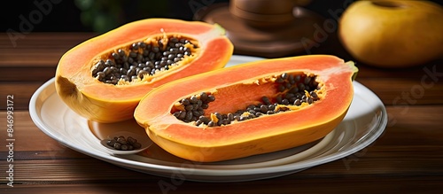 Halved papaya fruit with se...
