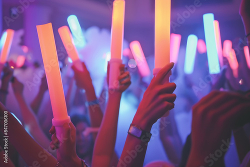 People Holding Led Foam Sticks In Their Hands At A Night Club At A Summer Party. Party Fun Summer Beach Happiness Concept. Ai Generated
