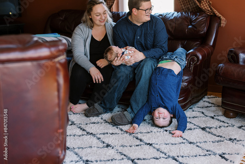 laughing upside down toddler at home being tickled