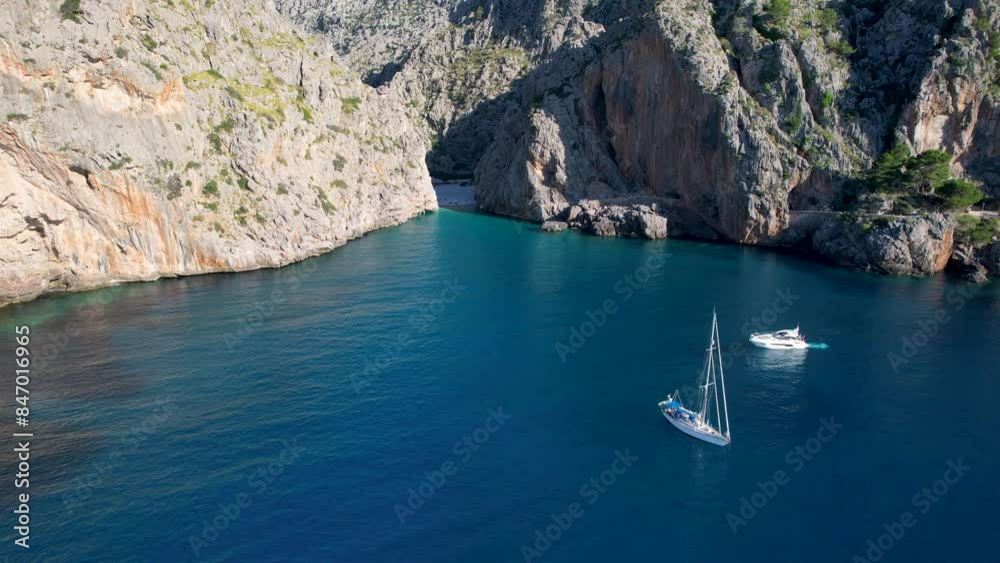 4K Aerial Drone video of unique beach carved into the canyon with turquoise blue water and boats anchored, Sa Calobra Beach, Mallorca, Spain 4K Aerial Drone video of unique beach carved into the canyon with turquoise blue water and boats anchored, Sa Calobra Beach, Mallorca, Spain