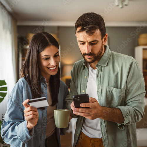 Couple and buy online on mobile phone with credit card at home