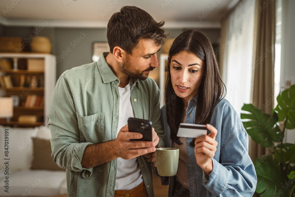 Couple and buy online on mobile phone with credit card at home
