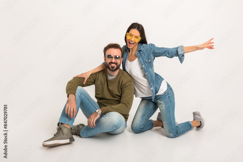 stylish couple sitting on floor in jeans stylish couple sitting on floor in jeans