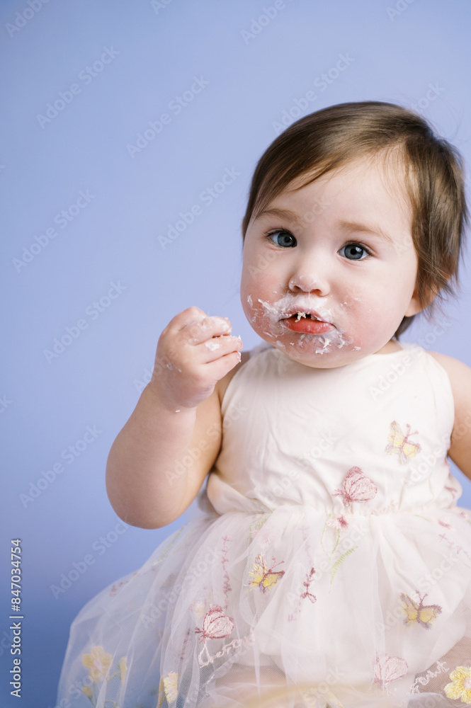 portrait of happy baby eating first cake on birthday portrait of happy baby eating first cake on birthday