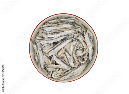 Marinated anchovy fillets in a ceramic bowl on white background. Top view.