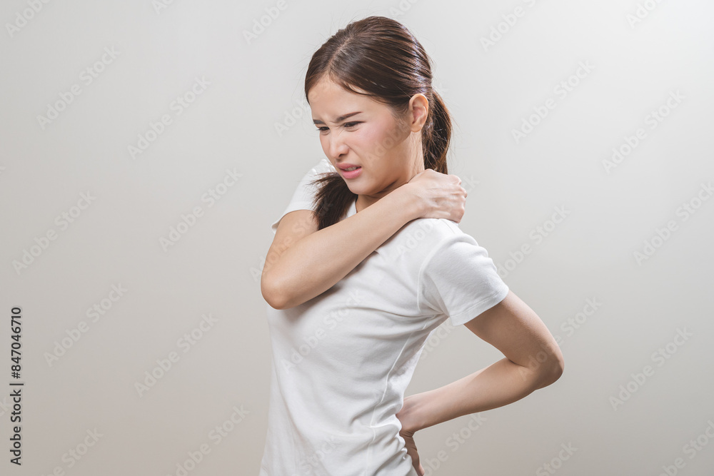 Pain body muscles stiff problem, asian young woman, girl painful with back, neck ache from work hand holding massaging rubbing shoulder hurt, sore on white background. Health care and medicine concept Pain body muscles stiff problem, asian young woman, girl painful with back, neck ache from work hand holding massaging rubbing shoulder hurt, sore on white background. Health care and medicine concept