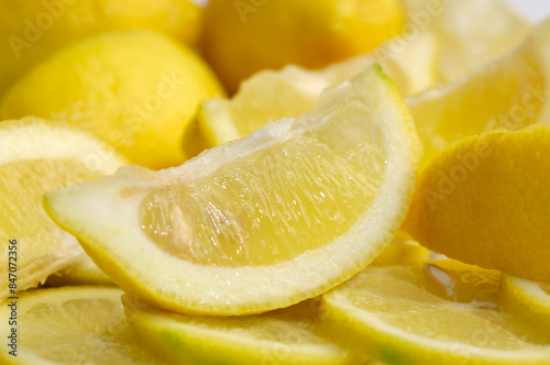 a piece of lemon on a background of lemons