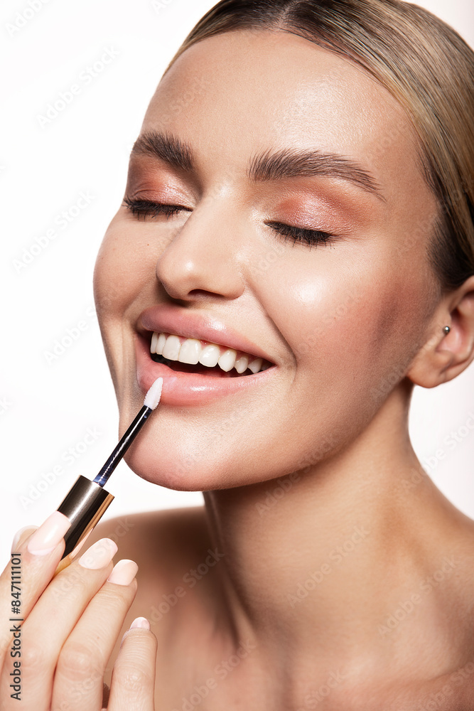Beauty portrait of model with natural make-up. Fashion shiny highlighter on skin, sexy gloss lips make-up Beauty portrait of model with natural make-up. Fashion shiny highlighter on skin, sexy gloss lips make-up