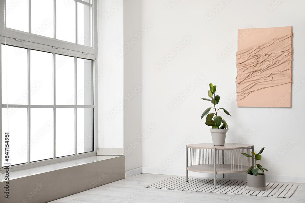 Fototapeta premium Table with Ficus trees in light room