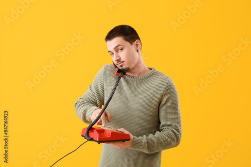 Young man talking by teleph...