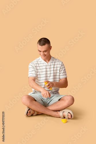Happy young man applying su...