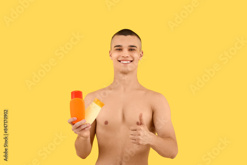 Happy young man with bottle...