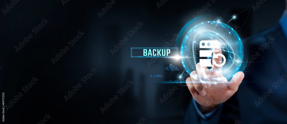 Fototapeta premium Backup Strategy: Businessman Touching Backup Icon for Data Protection and Global Network Accessibility. Ensuring Continuity, Disaster Recovery.