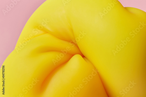 Wallpaper Mural Yellow coloured material folded in tight swirl on pink background Torontodigital.ca