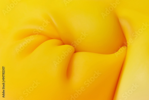 Yellow substance shrinking under pressure and creating folds photo