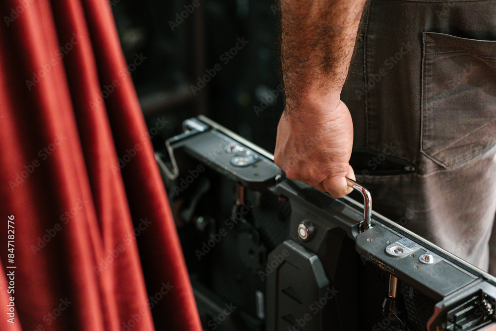 Hand of anonymous man standing and carrying LED video panel Hand of anonymous man standing and carrying LED video panel