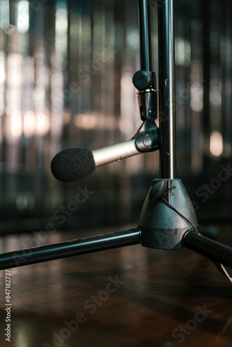 Microphone connected on tripod placed on stage photo
