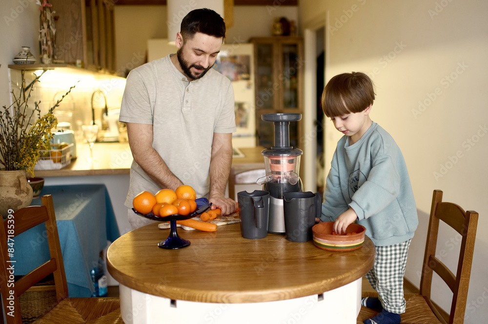 father with his son making juice father with his son making juice