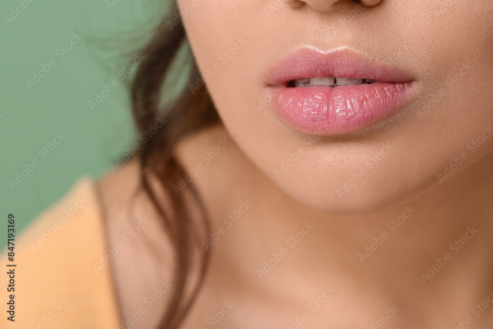 Fototapeta premium Woman with beautiful lips on green background, closeup