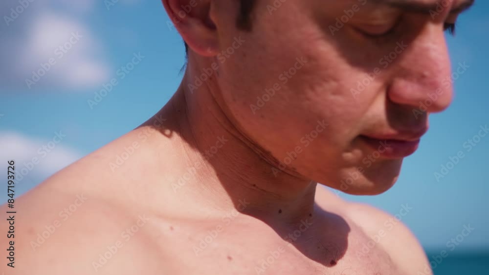 Boy Does Neck Stretching Exercises On The Beach By The Sea Boy Does Neck Stretching Exercises On The Beach By The Sea