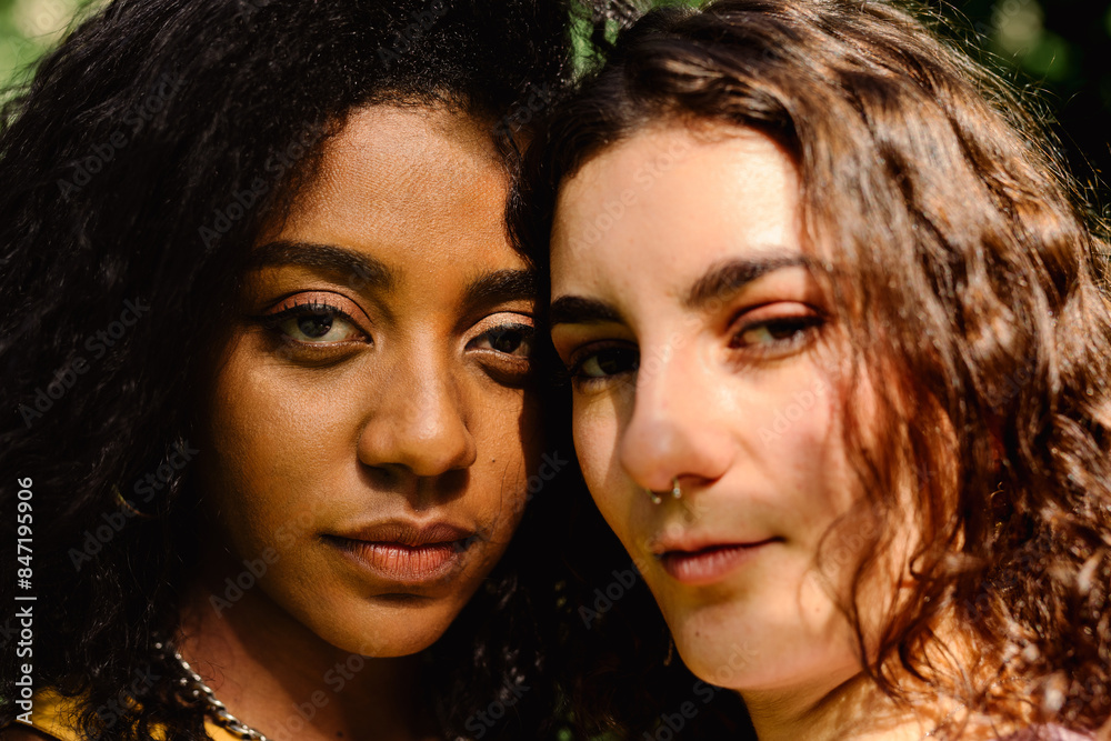 Portrait facing the camera of curly-haired women of different culture Portrait facing the camera of curly-haired women of different culture