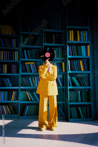Unrecognizable woman with gramophone record in library