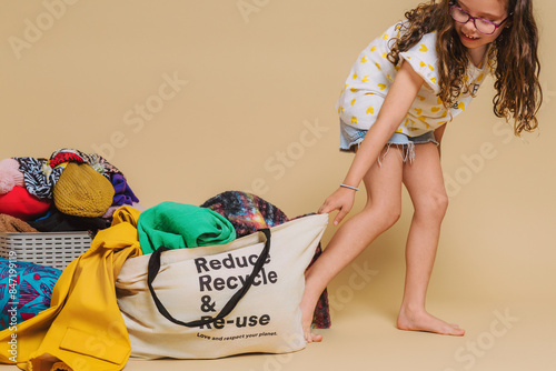 kid with recycling clothes bag 
