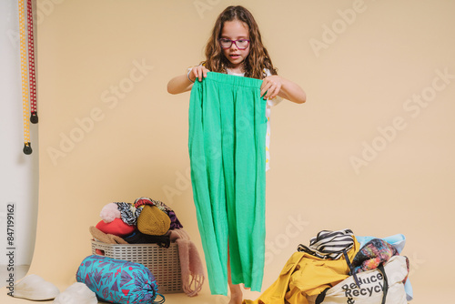 Child Trying On Green Pants photo