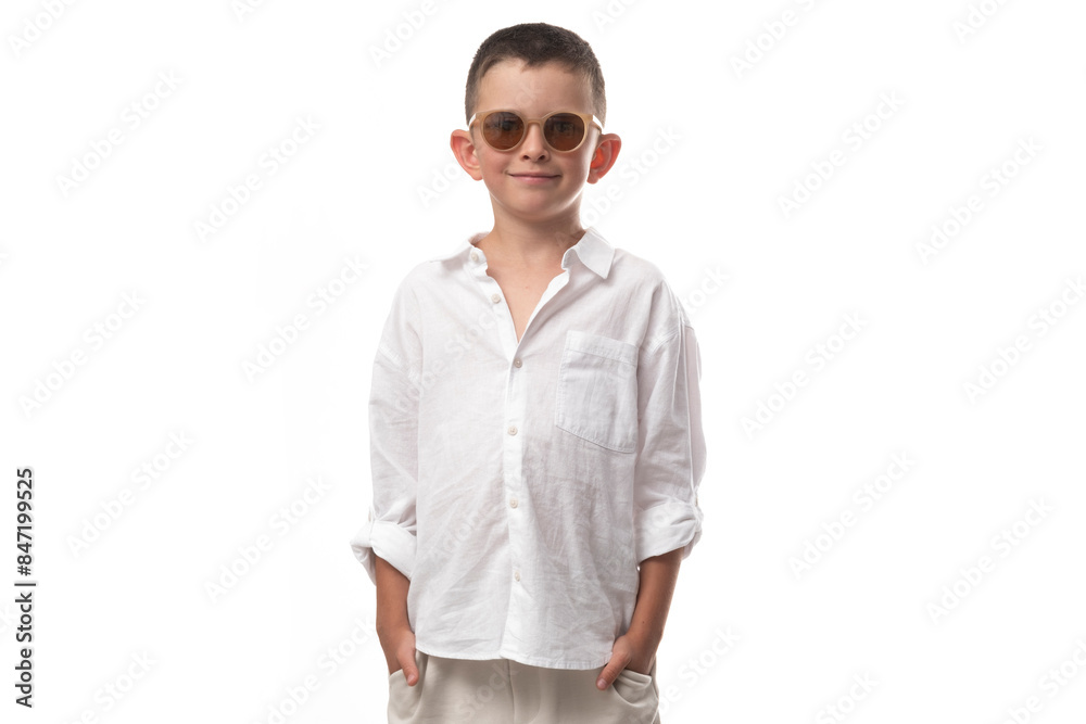 Handsome little boy in a muslin shirt, beige pants and leather sandals on a white background. Fashionable modern look! Handsome little boy in a muslin shirt, beige pants and leather sandals on a white background. Fashionable modern look!