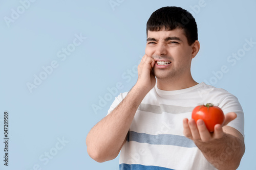 Young man with tomato suffe...