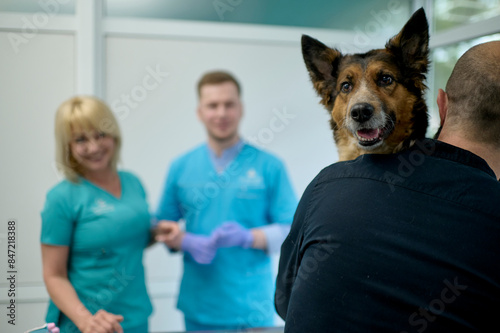 Young man with his dog in a clinic photo