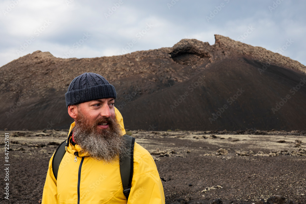 bearded man hiking on a volcano bearded man hiking on a volcano