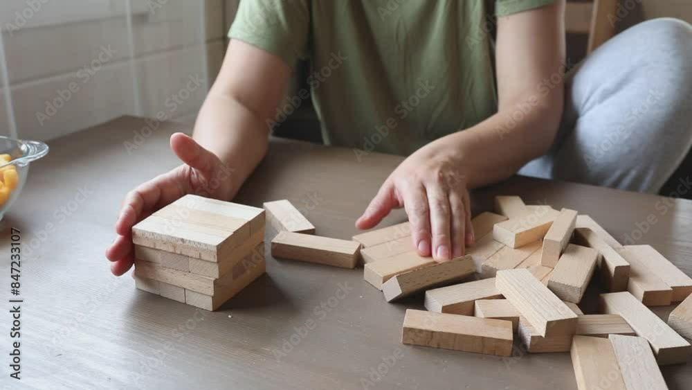 Mother and Son Play Jenga Game in Home Mother and Son Play Jenga Game in Home