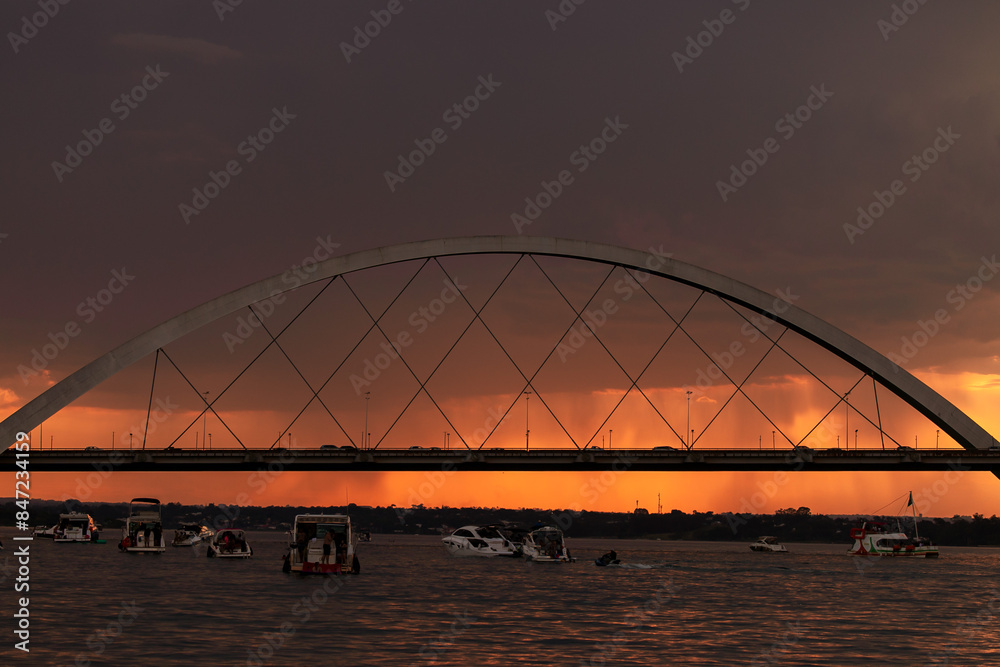 Naklejka premium Sunset over the Paranoa Lake with rain in the background