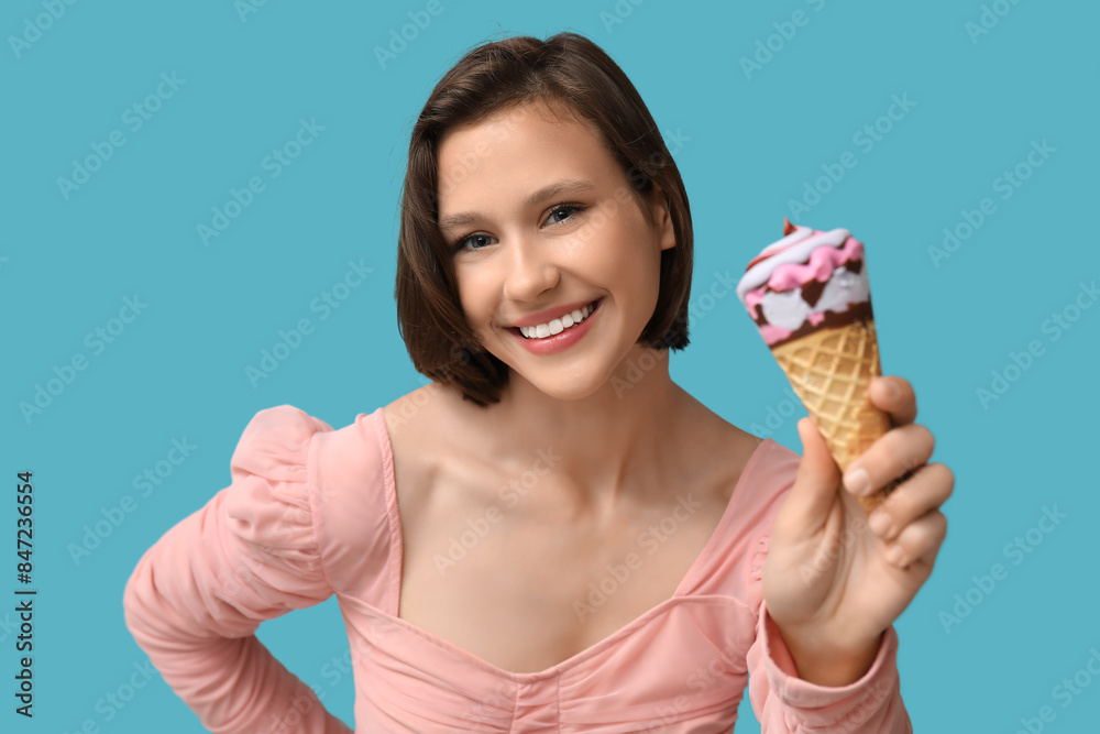 Happy young woman with sweet ice-cream in waffle cone on blue background Happy young woman with sweet ice-cream in waffle cone on blue background