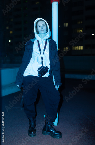 Non binary person with camcorder on the street photo