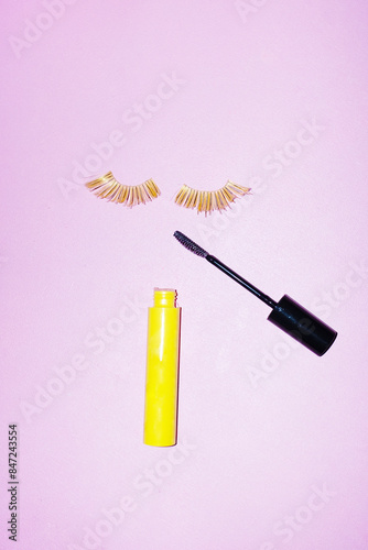 Beauty products: golden shiny lashes and makeup mascara and hard flash