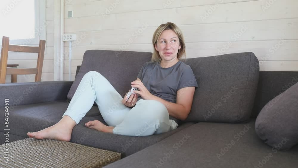 Woman Lays Out Playing Cards on Couch in a Modern Home Woman Lays Out Playing Cards on Couch in a Modern Home