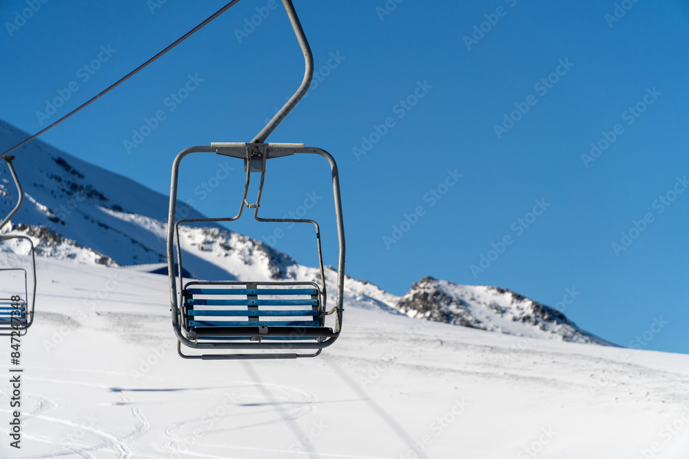 View of a ski lift chair at a ski resort, capturing the essence of winter sports and the excitement of skiing adventures