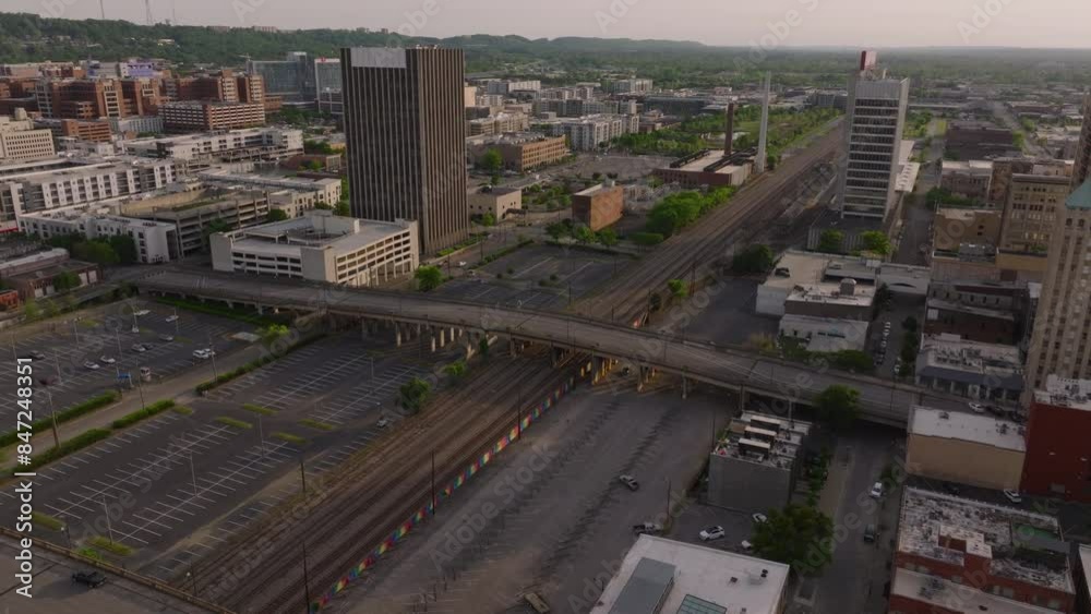 Aerial view of Birmingham, USA, railway system at dusk. Tall buildings, highway traffic, and urban landscape. Serene evening ambiance in the cityscape Aerial view of Birmingham, USA, railway system at dusk. Tall buildings, highway traffic, and urban landscape. Serene evening ambiance in the cityscape